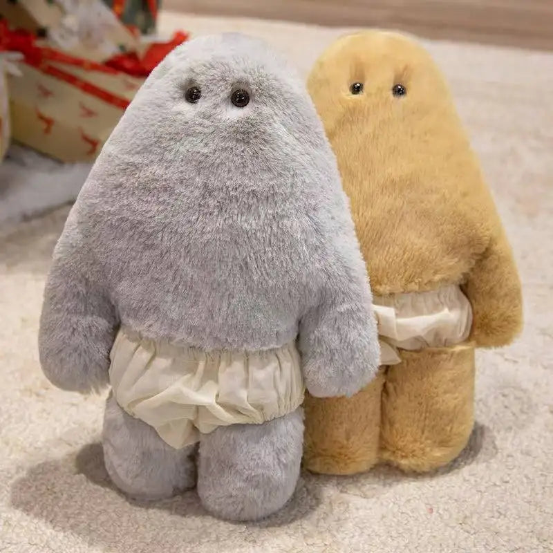 A pair of soft, cuddly monster plush dolls in gray and tan colors with pants.