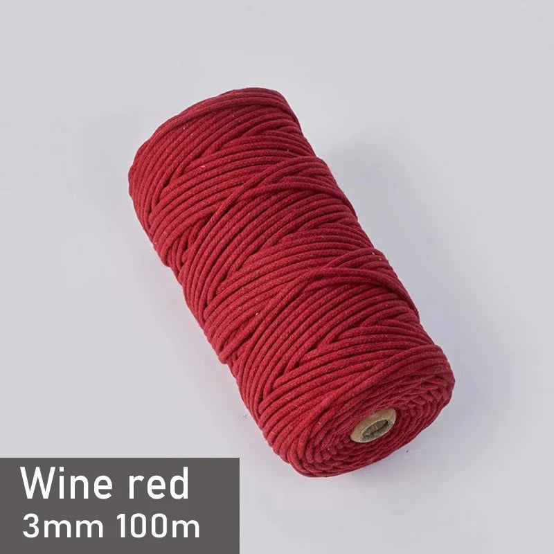 A spool of wine red 3mm cotton macrame cord measuring 100 meters.