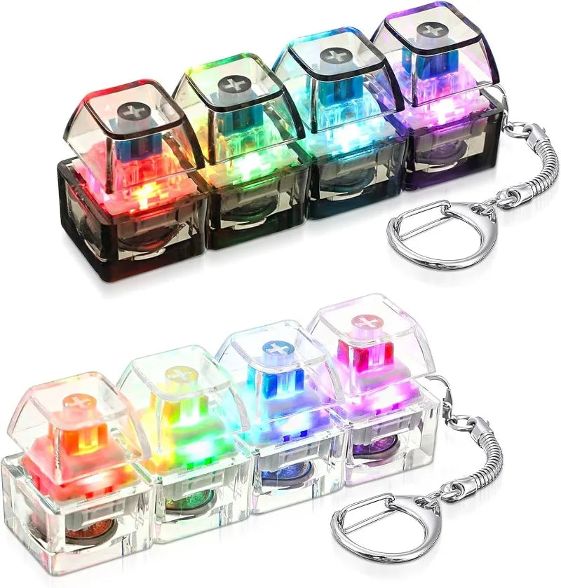 A set of illuminated stress-relief keychain toys featuring colorful keyboard buttons.