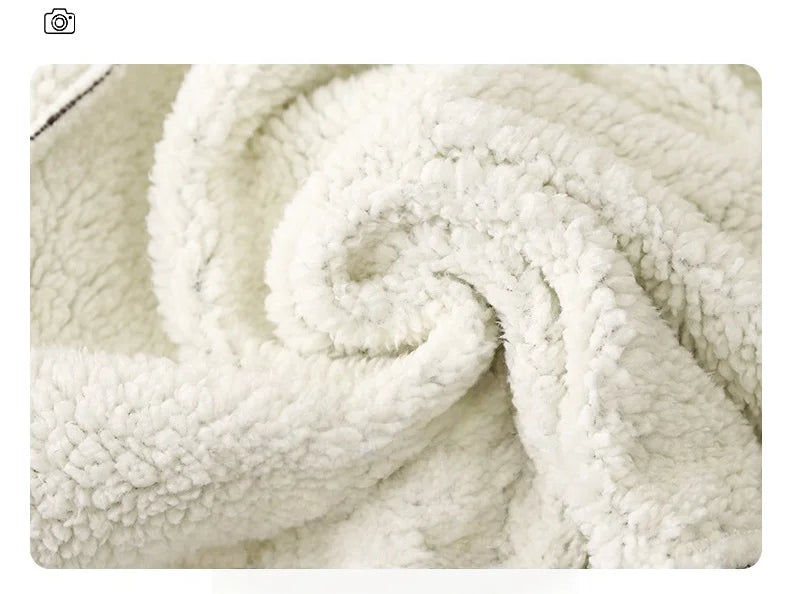 Close-up of a white fleece fabric with a soft, curly texture and subtle polka dot pattern.