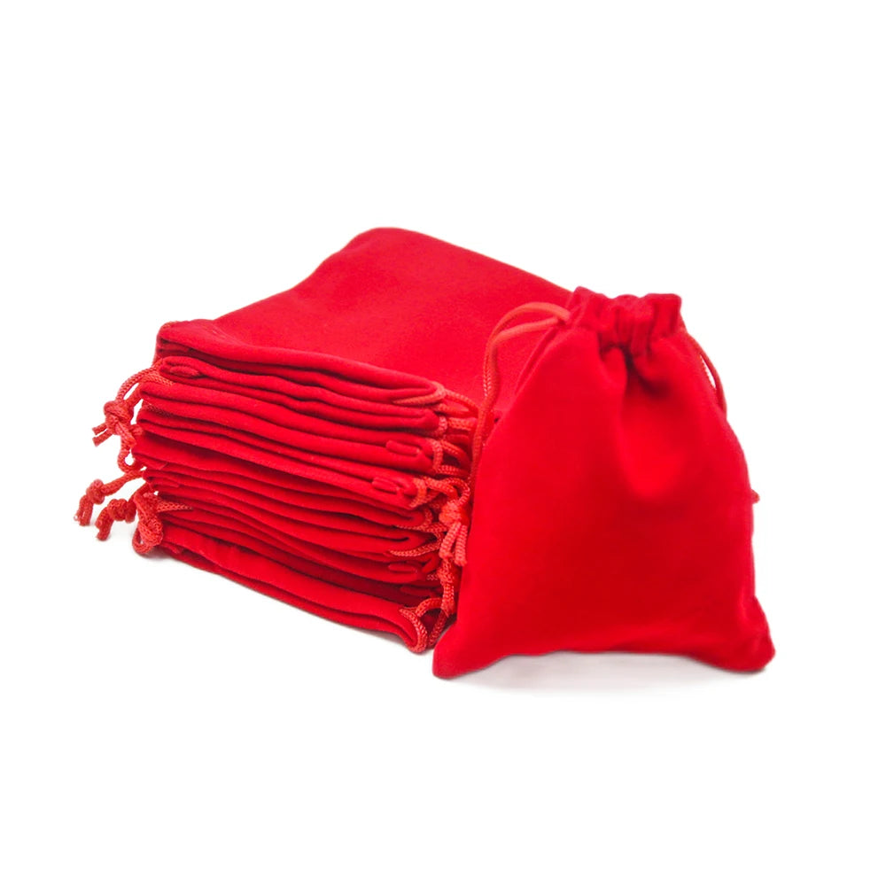 A stack of red drawstring dice bags for tabletop games.