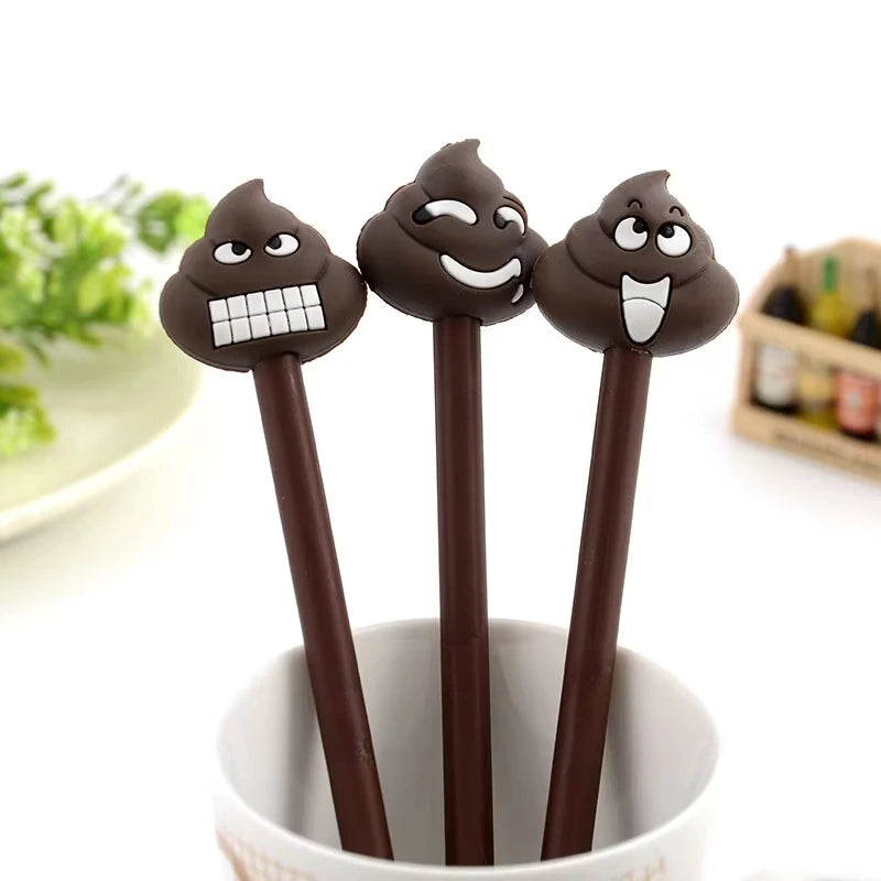 A pack of three dark brown novelty cartoon poop gel pens standing upright in a white cup.
