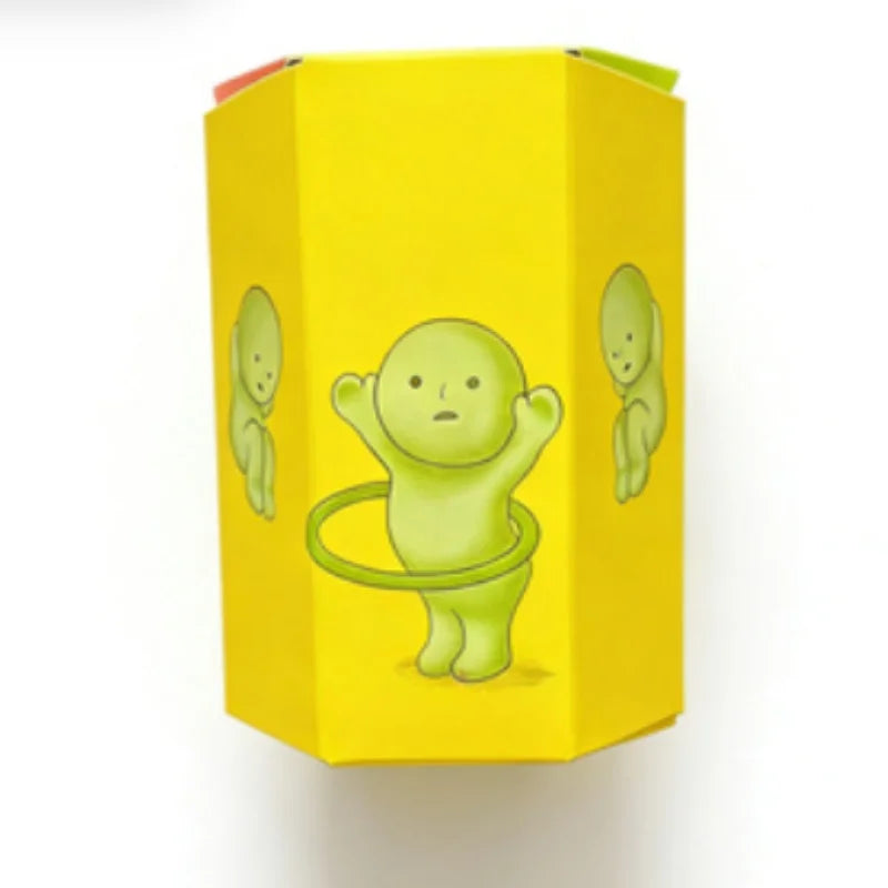 A yellow cardboard box featuring a green, round, humanoid figure design.