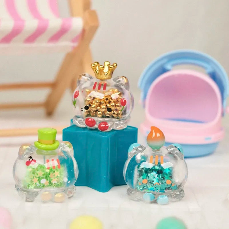 A clear glass figurine of an octopus cat with a gold crown and strawberry mousse tower charm