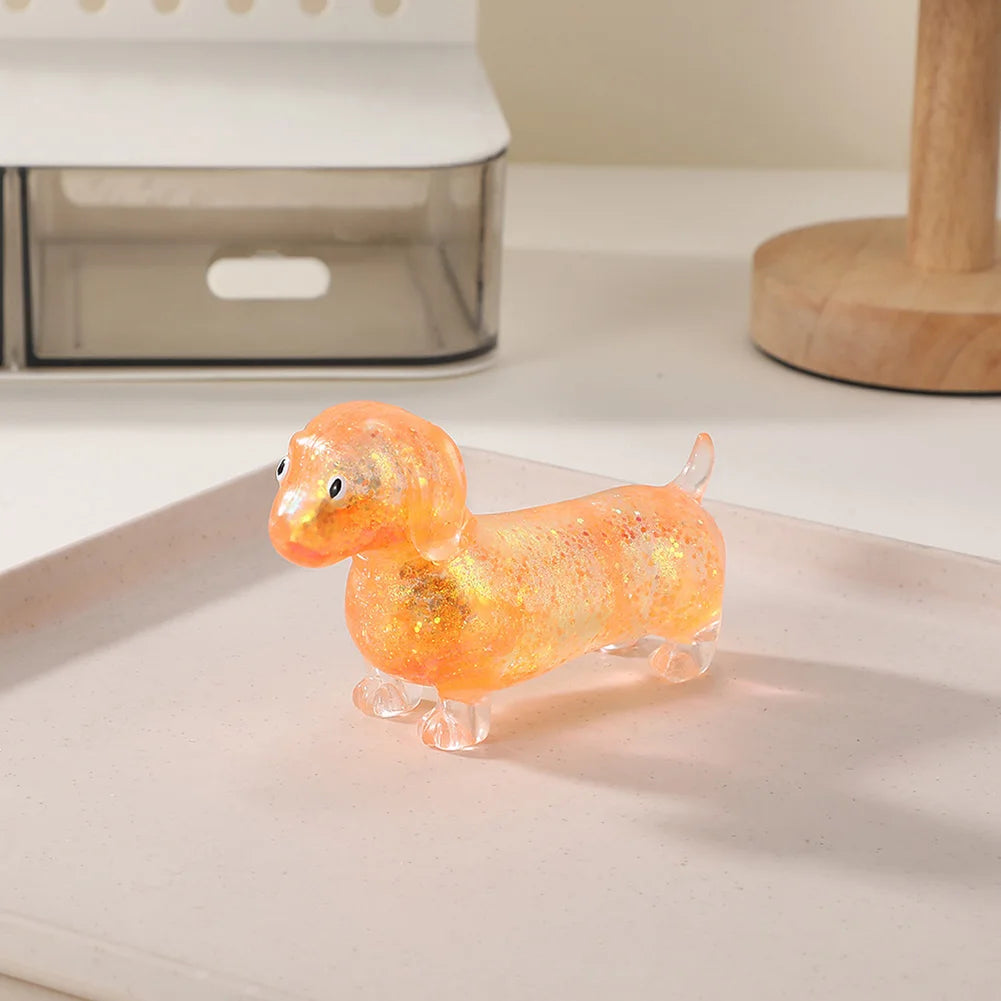 An adorable, squishy stress relief toy shaped like a dachshund in a translucent orange color.