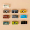 A collection of branded building block sets and coins displayed on a light beige background.