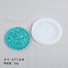 A teal silicone resin mold set featuring heart, round, oval, and rectangle shapes displayed on a light gray cloth.