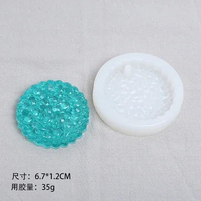 A teal silicone resin mold set featuring heart, round, oval, and rectangle shapes displayed on a light gray cloth.