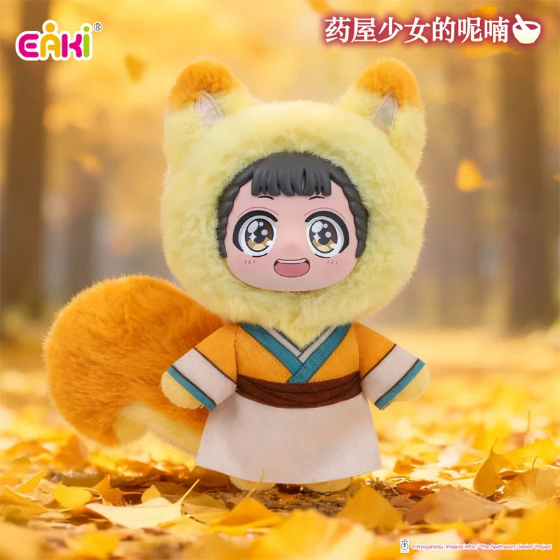 A plush blind box of a girl character with yellow fur and orange clothing sitting on autumn leaves.