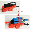 An orange toy gun set with a black web shooter accessory and blue cylindrical projectiles.