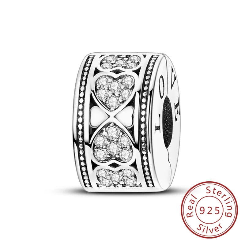 A silver heart charm bead for bracelets featuring intricate patterns and a love motif.
