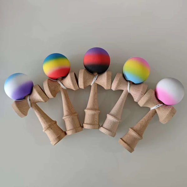 A set of seven wooden fitness balls painted with vibrant graffiti colors arranged in a circular pattern.