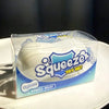A clear plastic package of a white squishy stress ball labeled Squeezzer Try Me Stress Relief