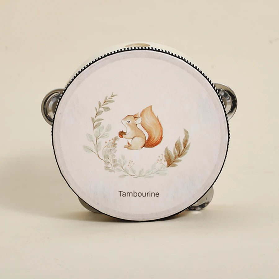 A round wooden tambourine with a painted bear illustration and gold accents.