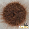 A close-up of dark brown long-haired alpaca blend yarn used for knitting, showing the fiber texture.