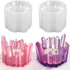 A set of clear silicone candle molds shaped like crystals in pink and purple colors.