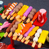 A colorful assortment of mini barbecue food items like sausages, cheese, and vegetables arranged on a red tray.