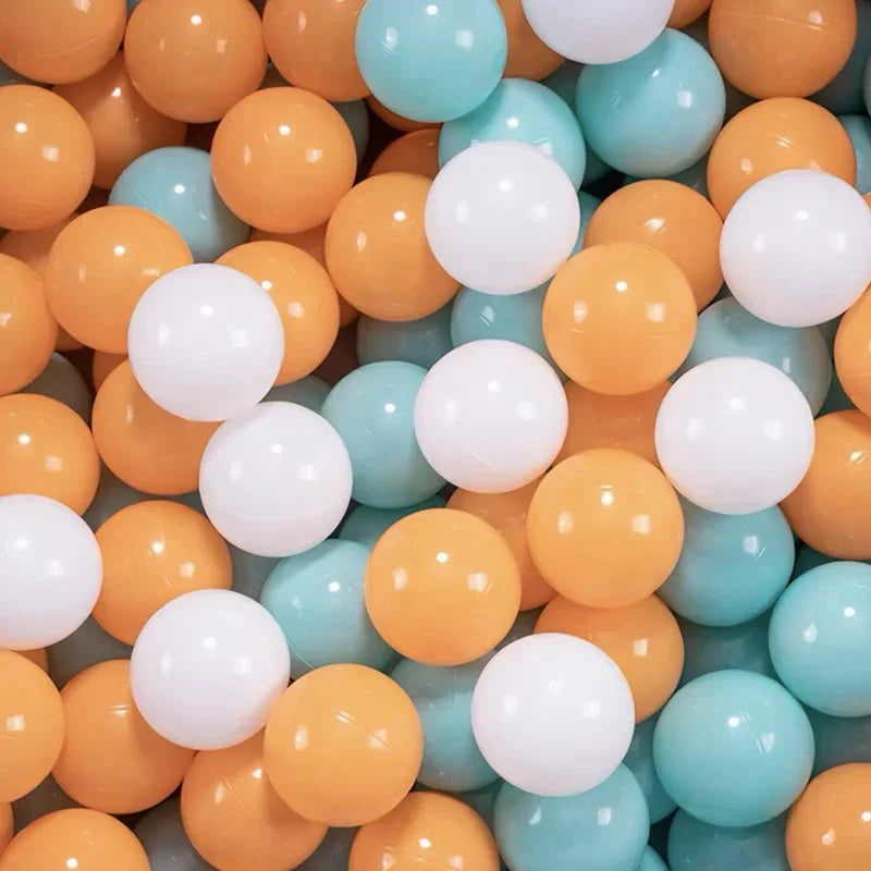 A close-up view of a large pack of colorful plastic balls in shades of orange, yellow, and light blue.