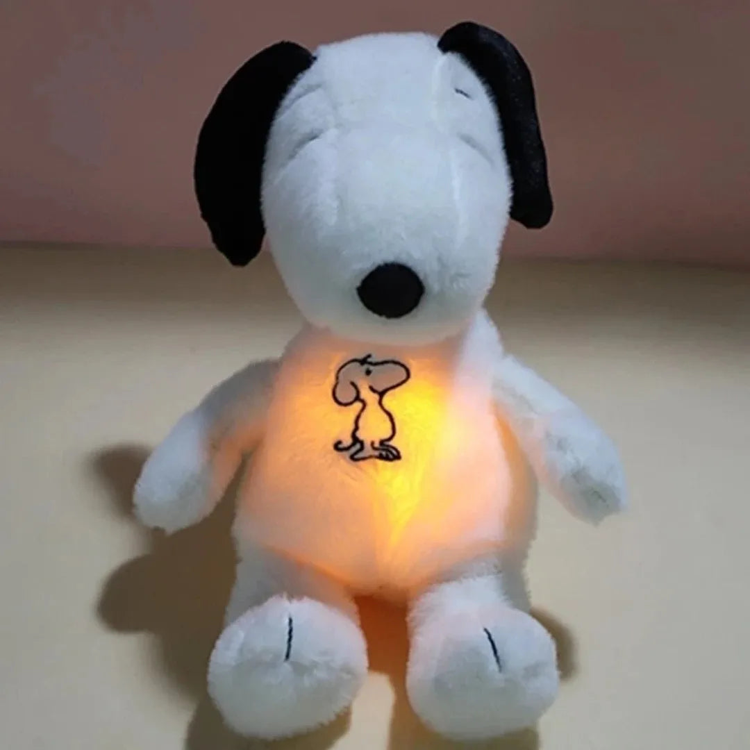 A white plush toy of Snoopy with black ears, glowing from within.