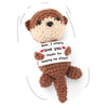 A handmade crochet brown animal plush doll with embroidered features and a note that reads I utterly love you thanks for keep