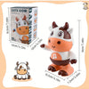 A plush toy of a cow with dancing features and lights, shown next to its packaging.