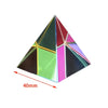 A geometric prism cube made of colored glass or acrylic, displaying various vibrant colors like green, pink, and red.