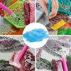 Close-up of diamond painting clay in various colors and textures being applied to a grid surface with a tool.
