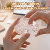 Hands hold a clear, squishy stress relief ball with bubbles for anxiety and pressure release.