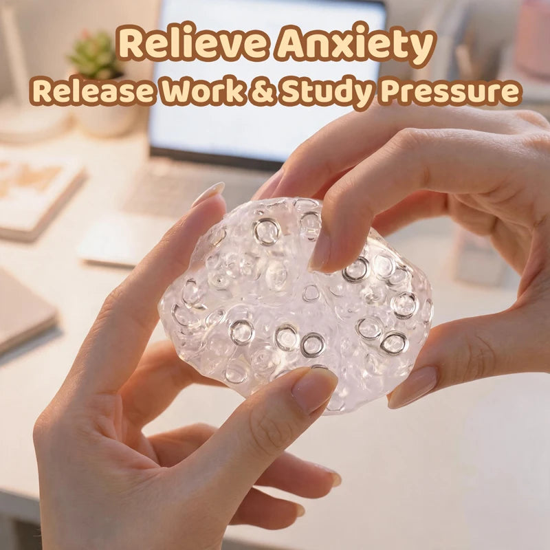 Hands hold a clear, squishy stress relief ball with bubbles for anxiety and pressure release.