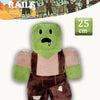 A soft green plush toy resembling a rabbit or creature, dressed in brown overalls.