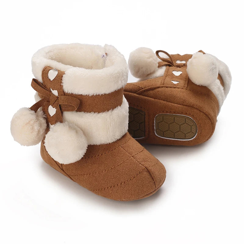 A pair of brown animal-themed baby first walker shoes with light fur trim and leather accents.