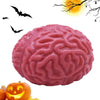 A pink, brain-shaped stress relief ball is shown next to a carved pumpkin.