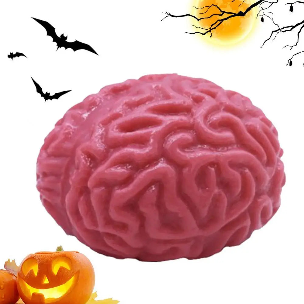 A pink, brain-shaped stress relief ball is shown next to a carved pumpkin.