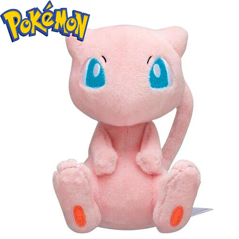 A pink, fluffy plush doll resembling a cat with blue eyes sitting down.