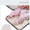 A pink baby changing mat is shown with a baby wearing a matching pink outfit, demonstrating no side leakage.