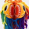 A colorful lion stuffed animal made of yarn with large embroidered eyes and multicolored yarn hair