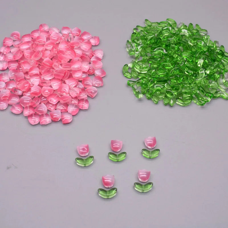 A pile of pink and green tulip flower glass beads.