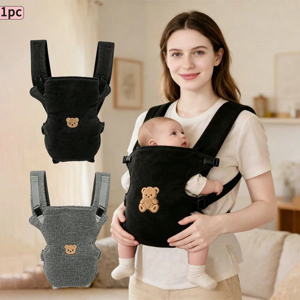 A woman is holding a black ergonomic multi-use baby carrier with a teddy bear design for a baby.