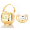 Gold-toned personalized baby pacifier with a crown design and storage case