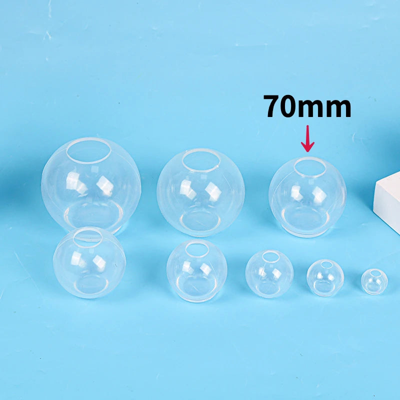 A set of clear silicone sphere molds for resin crafting, showing various sizes and a 70mm dimension.