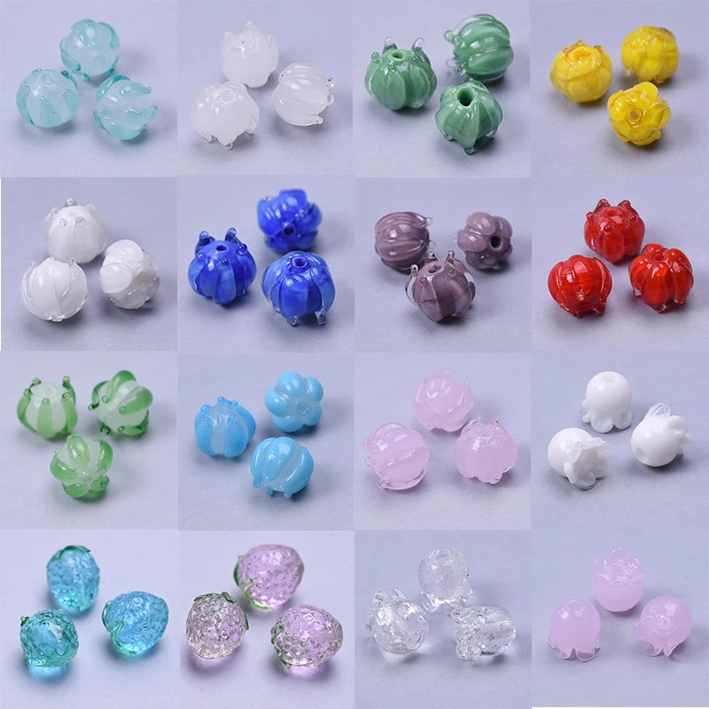 A collection of various colored glass charms and pendants for jewelry making, including blue, green, pink, and yellow shades.