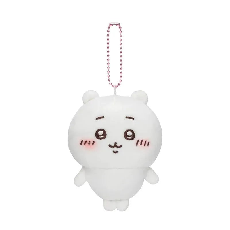 A white Chiikawa Usagi plush keychain charm with a pink beaded necklace.