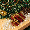 A close-up of a Christmas themed pearl diamond painting kit featuring green and red gems arranged in a festive frame.