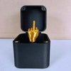 A black gift box with an open lid displaying a golden hand gesture.