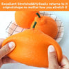 A hand is squeezing a realistic orange stress ball, demonstrating its stretchability.