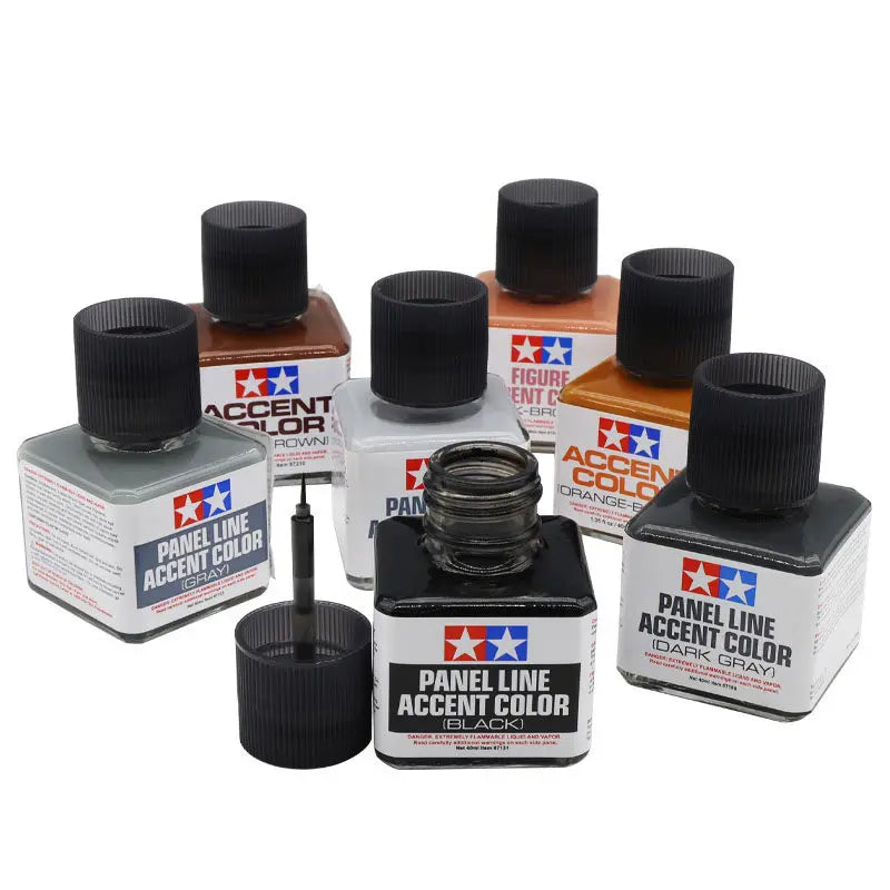 A collection of black enamel paint bottles for panel line accent color, including various shades and finishes.