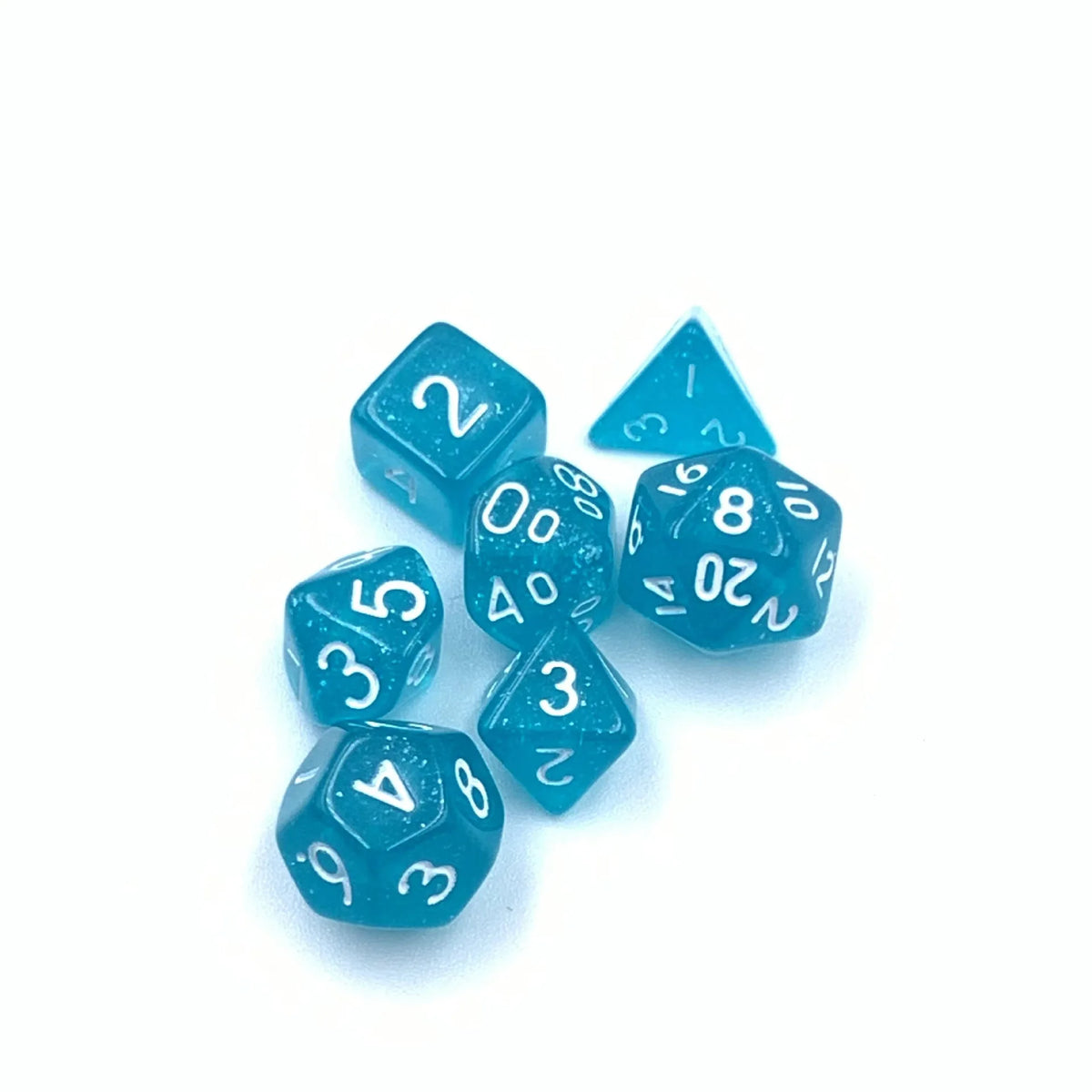 A collection of seven small, light blue polyhedral dice scattered on a white background.