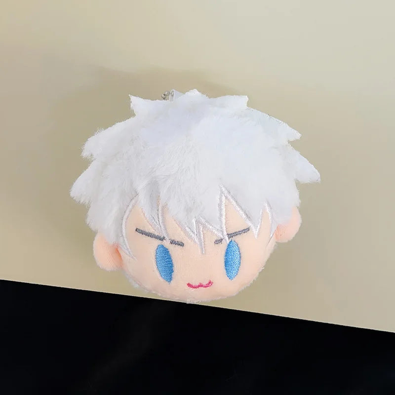 A white fluffy anime character plush keychain pendant with blue eyes and pink accents.