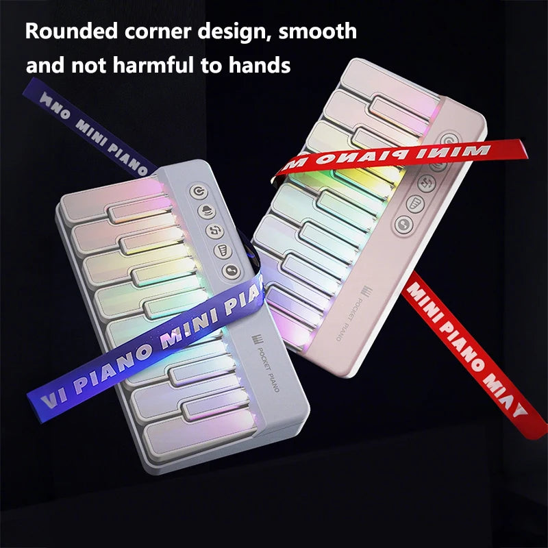A pink mini piano with rounded corners and colorful LED keys is shown against a dark background.