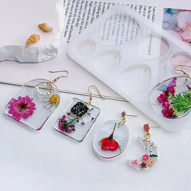 A collection of geometric silicone molds for epoxy resin earrings and pendants, featuring floral and natural elements.